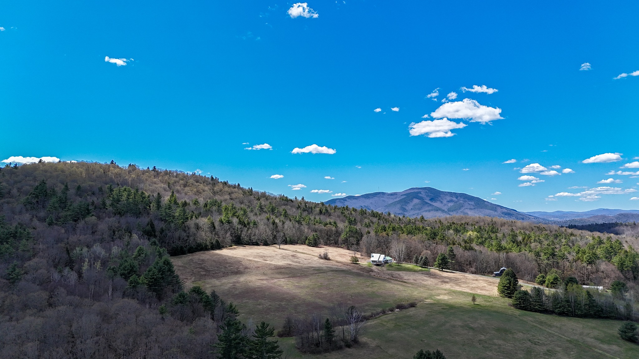 Cornish New Hampshire aerial field and mountain view under a bright blue sky