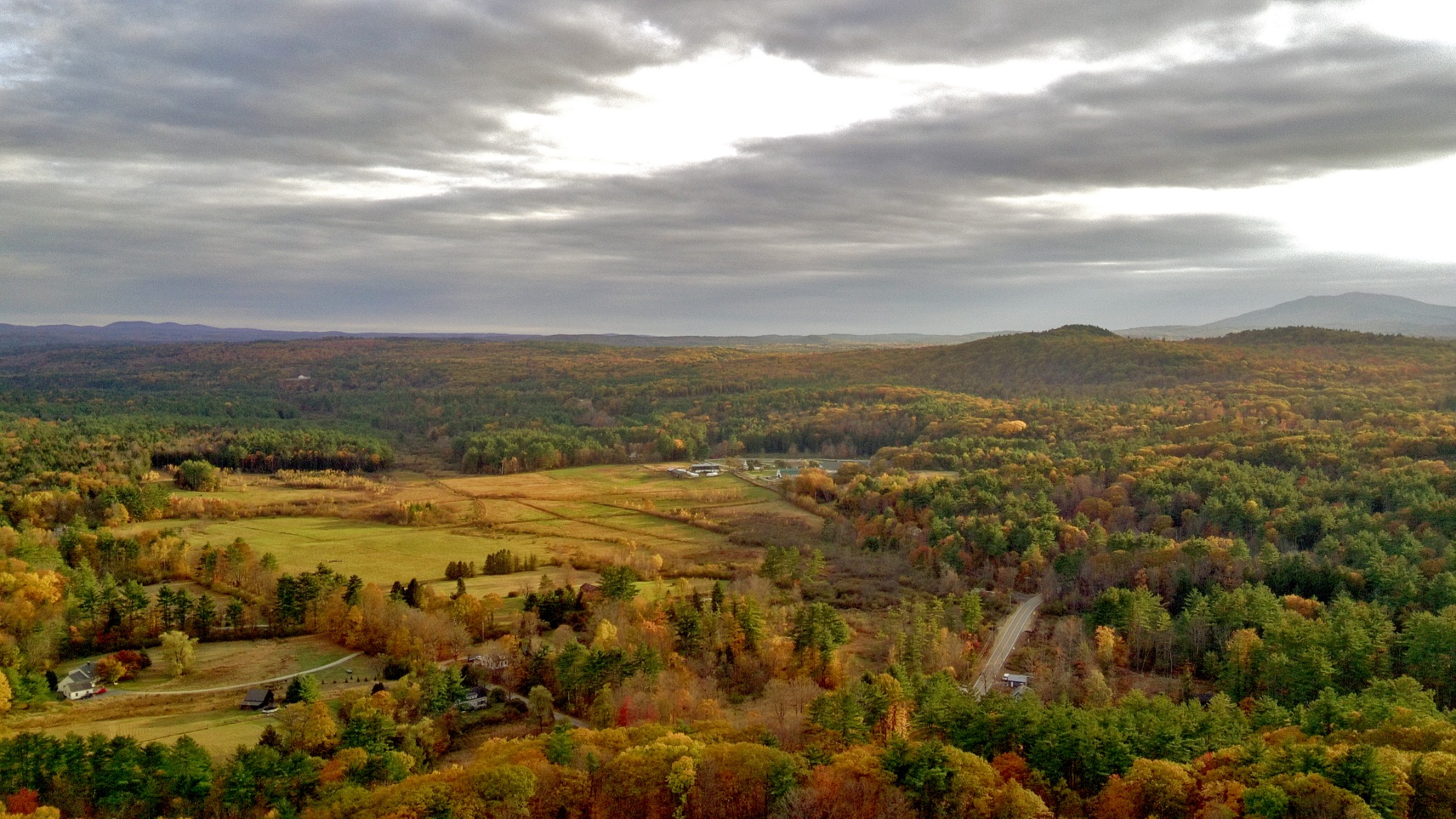 Hancock New Hampshire aerial field scene with fall color and surrounding hills